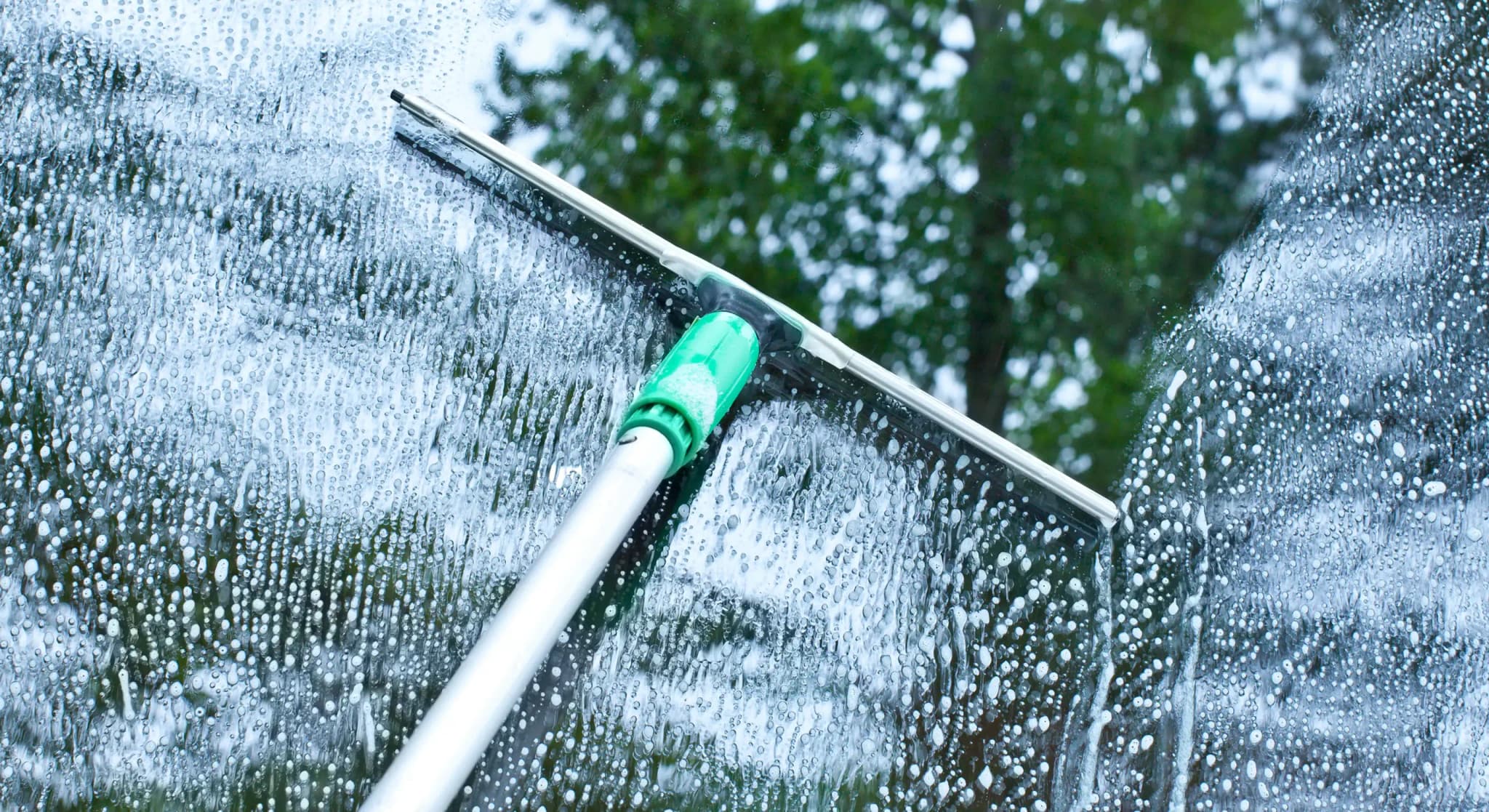 Professional window cleaner at work on residential property